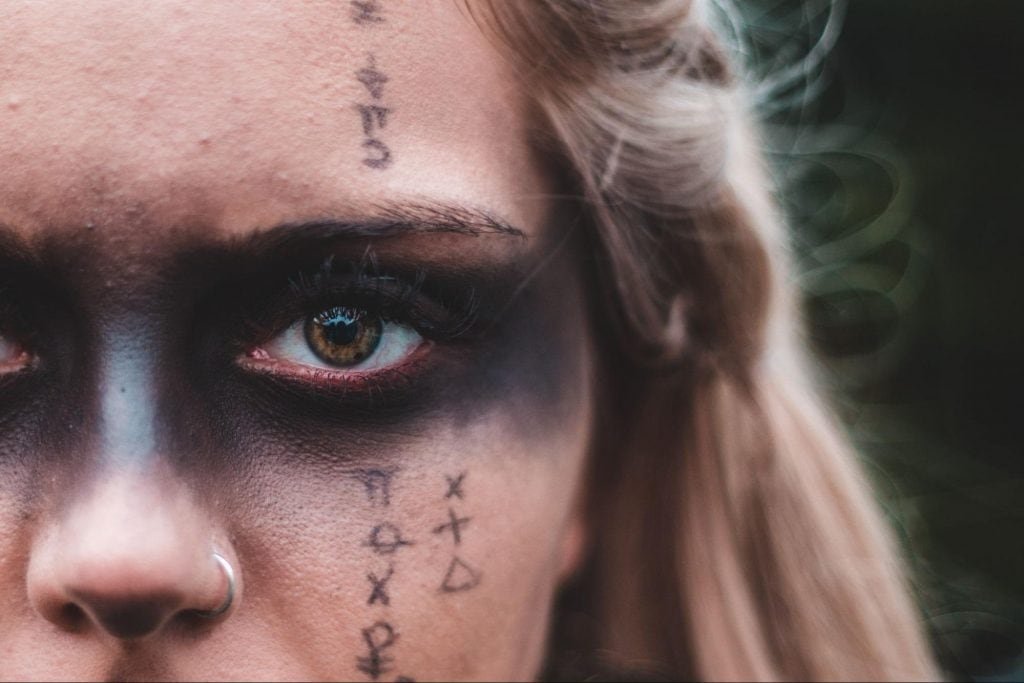 woman with black tattoo around the left eye