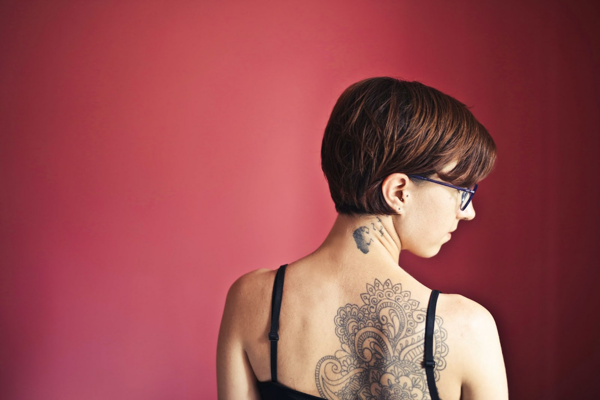 back tattoo on woman with short hair