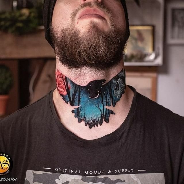 blue raven tattoo at the center of man's neck