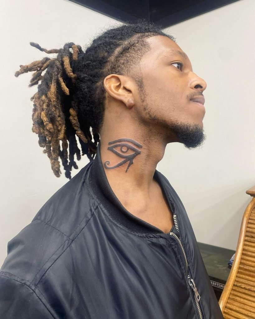 african man with eye of horus tattoo on neck