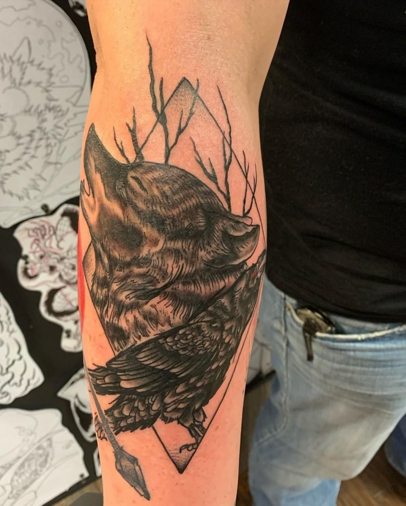 raven and wolf tattoo on arm