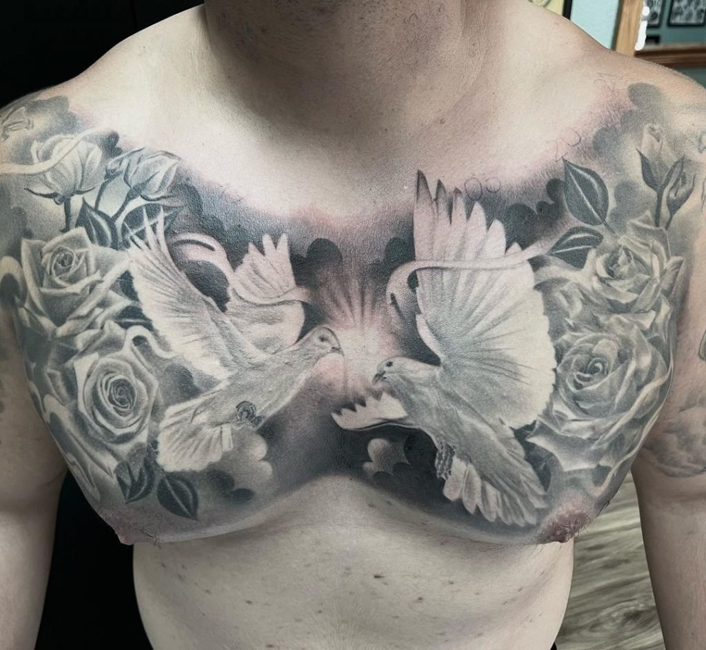 two doves facing each other on man's chest